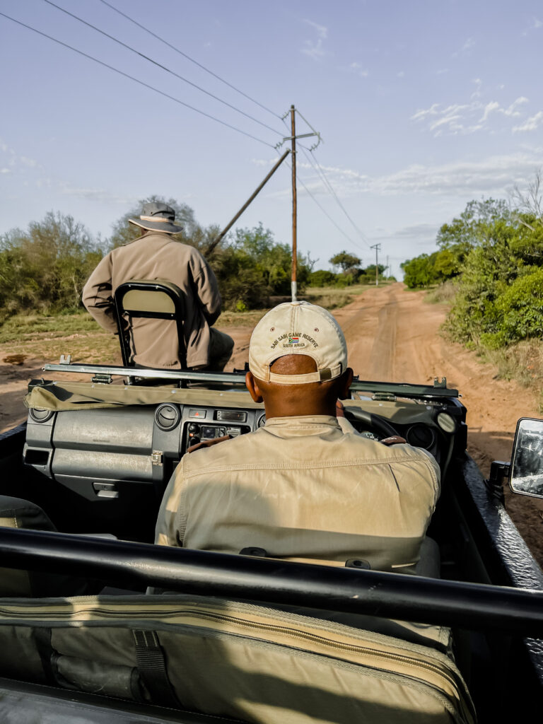 A safari truck driving through the bush during an African Safari Adventures